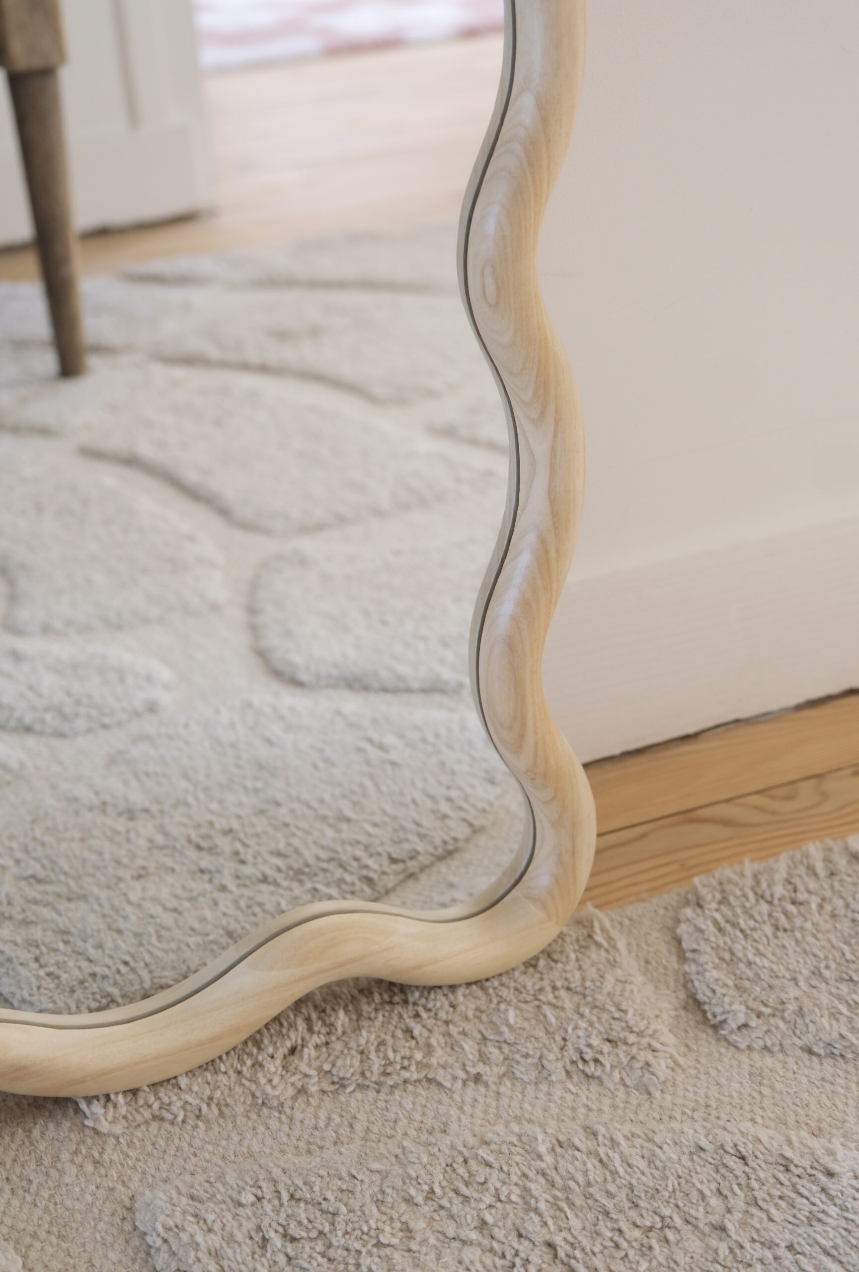 détail grand miroir ondulé bois clair